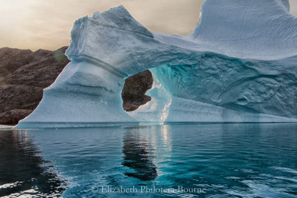 Beautfiul blue arched iceberg with reflection in Greenland
