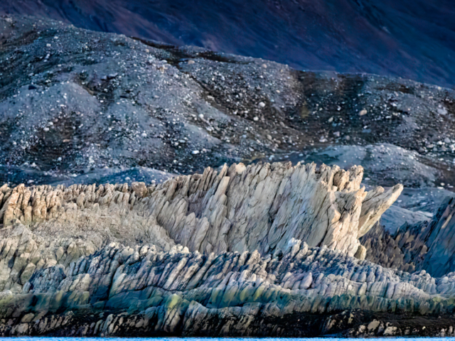 Photograph of different gray and blue rocks looking like stalagmites.