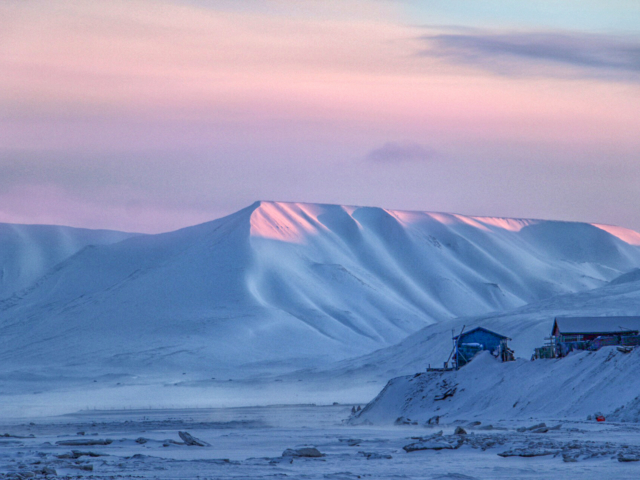 Return of the Sun Pastel pink sky and pale blue mountains announce the return of the sun to the high arctic town of Longyearbyen