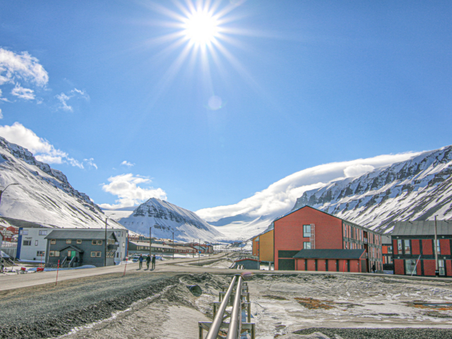 Midnight Sun Blue sky and midnight sun shining on the main road in a town in the high arctic