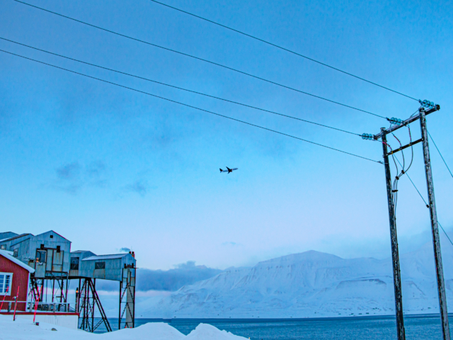 Outgoing SAS flight SAS jet flying out of Longyearbyen on a blue day in early spring