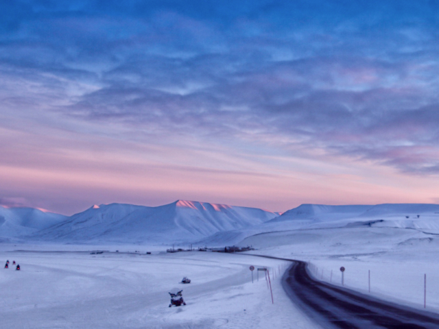 Scooter Season Snowmobiles coming home to Longyearbyen in the magical pastel light of early spring