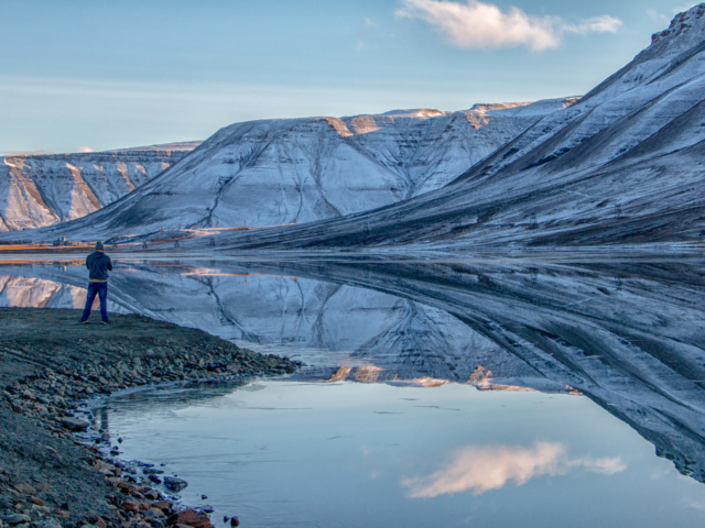 The Longyearbyen Reservoir Isdammen, the reservoir of drinking water for Longyearbyen Svalbard perfetly reflects the surrounding mountains