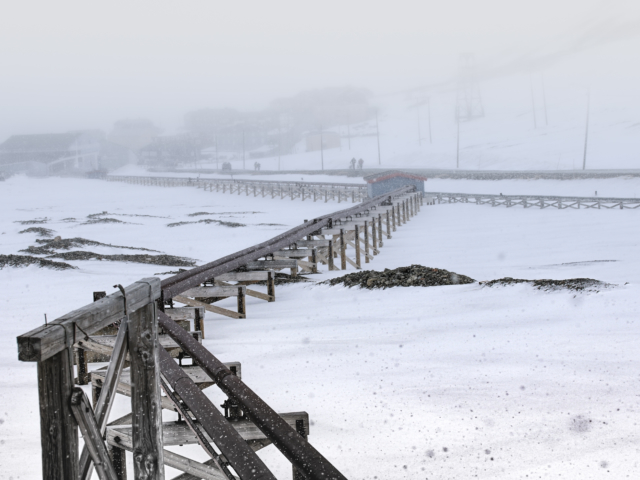 Water and Sewage Above ground pipes carrying water and sewage in a snowy landscape in longyearbyen Svalbard