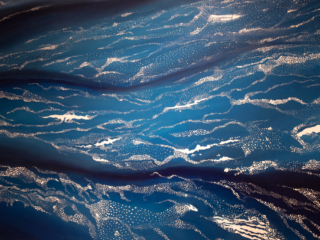 Section 1 of Loss and Change Painting of blue background with white dots and splotches of drift ice