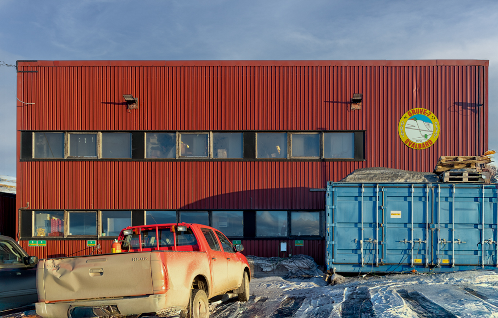 Mine 7/Gruve 7 Photograph of red metal building with mine 7 logo and trucks