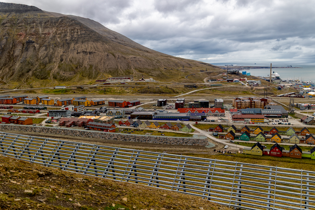 Changing Town Photograph of a view of avalanche fence and small buildings